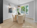 Recessed lighting with a contemporary pendant fixture, light wood-finish flooring, and a large window providing natural illumination - 9118 89 Street Nw, Edmonton, AB 