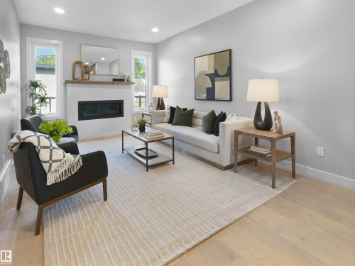 Recessed lighting, light wood-finish flooring, white walls, built-in electric fireplace with white surround, and wood mantel - 9118 89 Street Nw, Edmonton, AB 