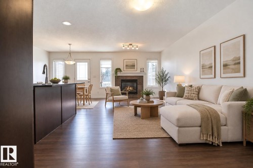 Open-concept living area featuring wood-finish flooring - 5205 168 Avenue Nw, Edmonton, AB 