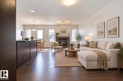 Open-concept living area featuring wood-finish flooring - 