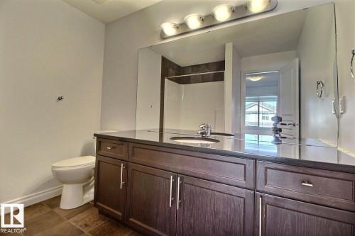 Dual vanity with dark wood-finish cabinetry and silver-tone hardware - 5205 168 Avenue Nw, Edmonton, AB 