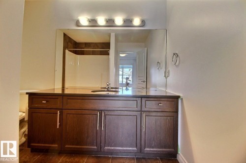 Dark wood-finish vanity with ample storage - 5205 168 Avenue Nw, Edmonton, AB 