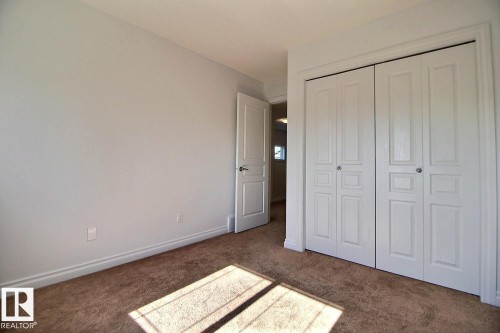 Soft neutral wall tones, carpeted flooring, and white trim - 5205 168 Avenue Nw, Edmonton, AB 