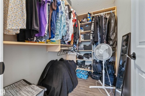 Built-in closet shelving and hanging rods with wood-finish flooring - #63 501 Youville Dr E Nw, Edmonton, AB 