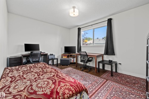 Recessed ceiling light fixture, wood-finish flooring, and a large window with a white frame - #63 501 Youville Dr E Nw, Edmonton, AB 