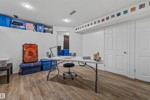 Wood-finish flooring, recessed lighting, and white paneled doors - #63 501 Youville Dr E Nw, Edmonton, AB 