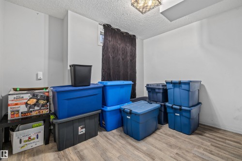 Recessed window opening, wood-finish flooring, textured ceiling, and an overhead lighting fixture - #63 501 Youville Dr E Nw, Edmonton, AB 