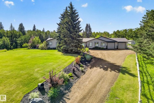 Spacious single-story residence with a gray exterior and dark trim - 22245 Twp Road 512, Rural Strathcona County, AB 