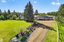 Spacious single-story residence with a gray exterior and dark trim - 22245 Twp Road 512, Rural Strathcona County, AB 