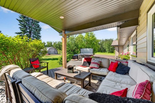 Covered outdoor patio featuring composite decking and recessed lighting - 22245 Twp Road 512, Rural Strathcona County, AB 