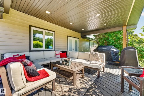 Covered outdoor deck with recessed lighting, composite flooring, and wood support beams - 22245 Twp Road 512, Rural Strathcona County, AB 