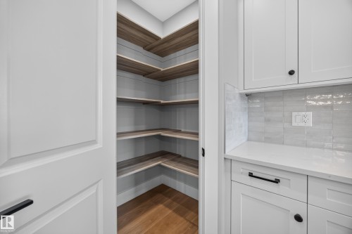 Walk-in pantry with wood-finish shelving and wood-finish flooring - 209 Hampshire, Sherwood Park, AB 