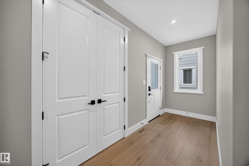 Light wood-finish flooring with white trim - 209 Hampshire, Sherwood Park, AB 