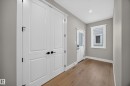 Light wood-finish flooring with white trim - 209 Hampshire, Sherwood Park, AB 