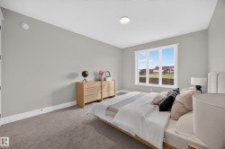 Recessed ceiling lighting, large window with multi-pane design, neutral wall color, and carpeted flooring - 