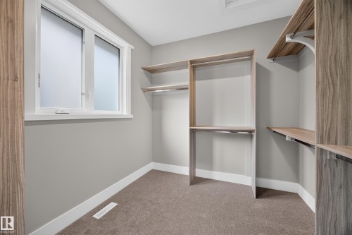 Built-in closet organization system with shelving and hanging rods - 209 Hampshire, Sherwood Park, AB 