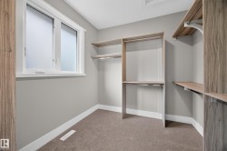 Built-in closet organization system with shelving and hanging rods - 