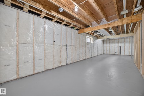 Spacious unfinished basement with exposed wood joists, insulated walls, and a concrete floor - 209 Hampshire, Sherwood Park, AB 
