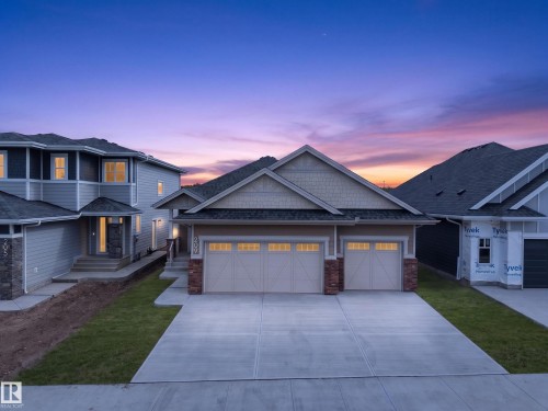 Two-car garage with panel-style doors and upper window inserts - 209 Hampshire, Sherwood Park, AB 