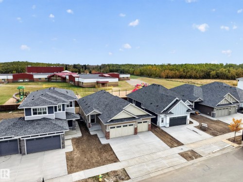 Newly constructed residential properties featuring concrete driveways and attached garages - 209 Hampshire, Sherwood Park, AB 