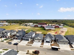 New construction residential properties with concrete driveways and attached garages - 