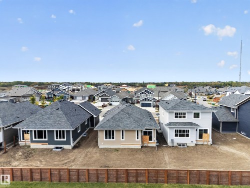 Newly constructed homes featuring various siding colors and roof styles, set within a developing residential community - 209 Hampshire, Sherwood Park, AB 