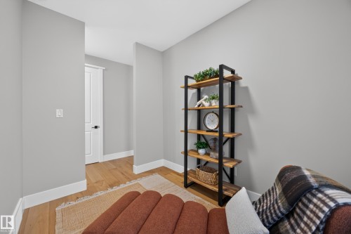 Wood-finish flooring with white baseboards, light gray walls, and white trim around interior doors - 209 Hampshire, Sherwood Park, AB 