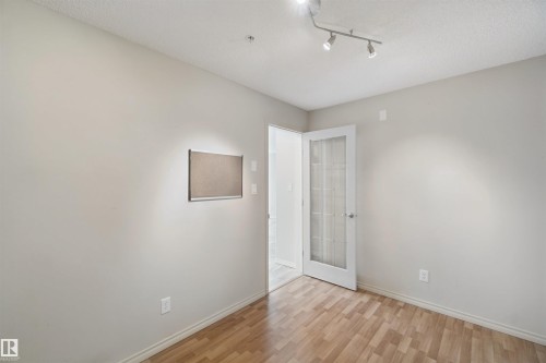 Wood-finish flooring with neutral wall paint - #208 16035 132 St Nw, Edmonton, AB 