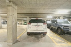 Underground concrete parking facility with designated parking spaces - 