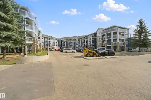 Multi-story residential building featuring balconies with glass railings - #208 16035 132 St Nw, Edmonton, AB 
