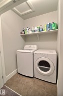 Tile flooring, white wall shelving, attic access panel - 
