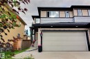 Multi-level exterior with light-colored siding and dark trim - 35 Hudson Cove, Spruce Grove, AB 