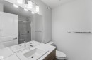 Vanity with an integrated rectangular sink, chrome faucet, and wood-finish cabinetry - 5733 Hawthorn Common Sw, Edmonton, AB 