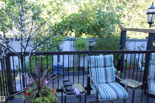 Expansive wooden deck with dark railing and integrated post lighting, offering an outdoor living area - 3815 41 Street Nw, Edmonton, AB 