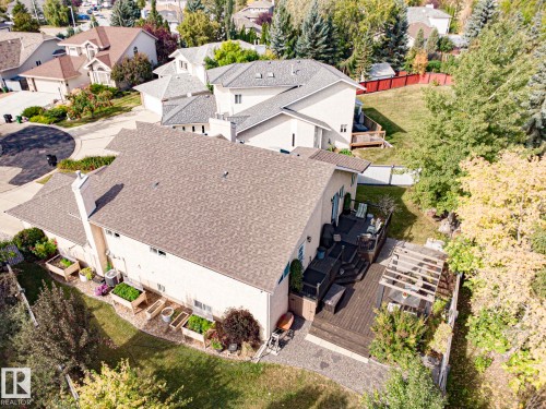 Expansive rear deck with pergola, stone patio, and raised garden beds - 3815 41 Street Nw, Edmonton, AB 