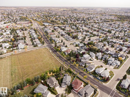 Expansive residential area featuring a central pond, established tree-lined streets, and varied single-family homes - 3815 41 Street Nw, Edmonton, AB 