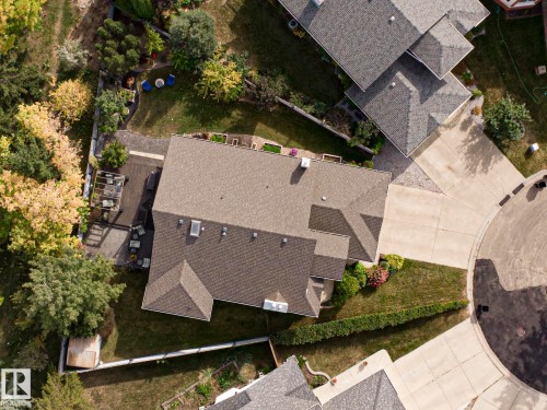 Property featuring a multi-gabled roofline, concrete driveway, and a backyard deck with a pergola - 3815 41 Street Nw, Edmonton, AB 