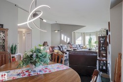 Open concept living area with vaulted ceilings, recessed lighting, and a contemporary linear light fixture Modern updated lighting. - 