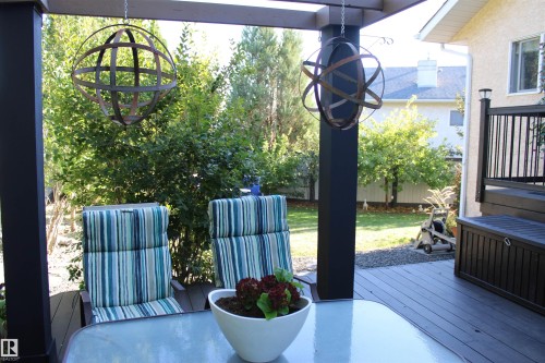 Deck 2 tiered with dark composite decking, black railing, and integrated storage box - 3815 41 Street Nw, Edmonton, AB 