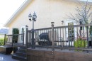 Multi-level deck with dark wood-finish railing, post-cap lighting, and a prominent decorative lamppost - 3815 41 Street Nw, Edmonton, AB 