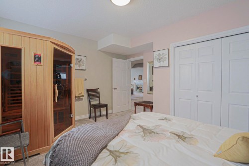 Built-in sauna with glass door, carpeted flooring, and bi-fold closet doors - 3815 41 Street Nw, Edmonton, AB 
