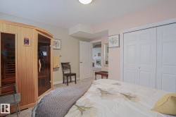 Built-in sauna with glass door, carpeted flooring, and bi-fold closet doors - 