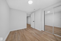 Wood-finish flooring, white walls, white trim, mirrored sliding closet doors, and recessed lighting - 