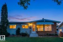 Single-story residence featuring a brick facade, multiple large windows, and a manicured front lawn - 12835 91 Street Nw, Edmonton, AB 