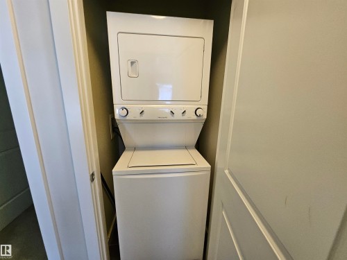 Stacked washer and dryer unit within an alcove - #69 903 Crystallina Nera Wy Nw, Edmonton, AB 