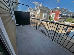 Private balcony with a dark privacy screen and black metal railing - 