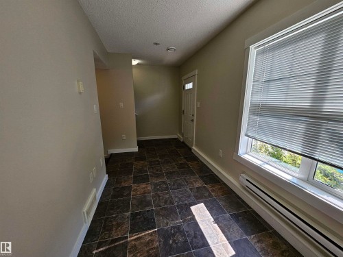 Tiled flooring, white trim, and a window with horizontal blinds - #69 903 Crystallina Nera Wy Nw, Edmonton, AB 