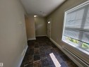 Tiled flooring, white trim, and a window with horizontal blinds - #69 903 Crystallina Nera Wy Nw, Edmonton, AB 