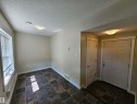 Entry area featuring a paneled door, flush-mount lighting, and textured ceiling - #69 903 Crystallina Nera Wy Nw, Edmonton, AB 