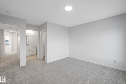 Plush carpeting, recessed ceiling lighting, and a neutral wall palette - 5239 - 5245 21A Avenue Sw, Edmonton, AB 